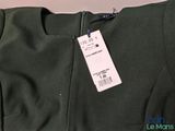 the back of a green jacket with a price tag on it