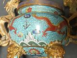 a blue and gold vase with a dragon on it