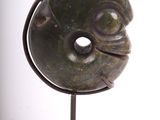 sculpture of a face on a stand on a white background