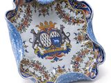 an image of a blue and white bowl with a coat of arms on it