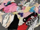 a pile of underwear on the floor next to a pair of scissors