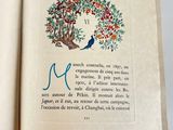 an open book with a picture of a bird in a tree