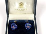 pair of blue glass earrings in a box with a key