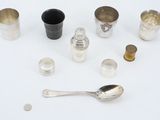 a silver spoon, a silver cup, a silver spoon, and a silver cup