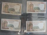 quatre billets de banque différents dans une vitrine sur laquelle figure l'image d'une femme