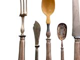 five different types of knives and spoons on a white background