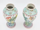 two vases that are sitting on a white surface