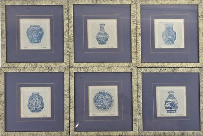 six framed blue and white vases on the wall
