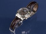 an image of a watch on a blue surface with a reflection