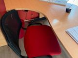 a desk with a chair and a computer on it