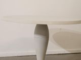 an image of a white table with a white top and a black base