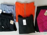 three pairs of women ' s leggings with tags on them