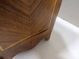 a close up of a corner of a wooden cabinet