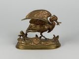 statue en bronze représentant un oiseau avec un autre oiseau perché sur son dos