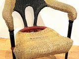 a wicker chair sitting on a hard wood floor