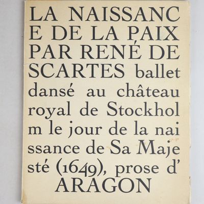 a black and white sign on a white wall with writing on it