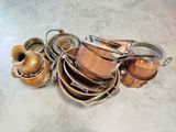 une pile de casseroles et de poêles posée par terre