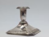 a silver plated candle holder on a white background