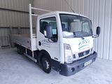 a white truck that is parked inside of a building
