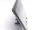 a tablet computer sitting on a stand on a white surface
