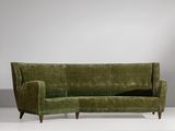 an image of a green couch sitting on top of a white floor