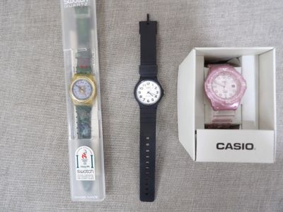 a watch in a box next to a watch in a box