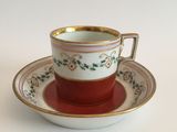 a cup and saucer on a saucer on a white table