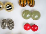 many different types of earrings on a white surface