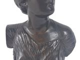 statue d'une femme en robe, posée sur un socle, sur fond blanc