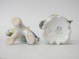 two figurines that are sitting next to each other on a table