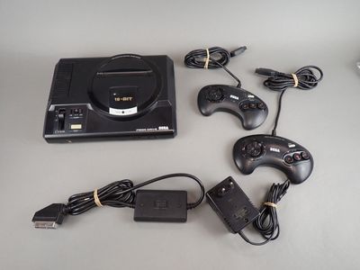 a video game system sitting on a table next to a charger