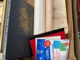 a box of books and papers on the floor
