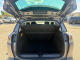 the back end of a car with its trunk open in a parking lot