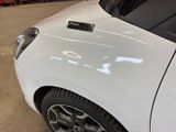 a close up of a white car with a sticker on it ' s side