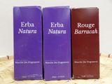 three boxes of perfume sitting on top of a wooden table