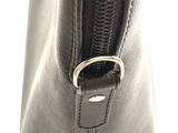 the inside of a black purse with a metal ring on it