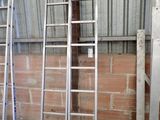 three ladders that are leaning up against a wall