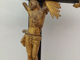 a statue of jesus on a cross with a bird on it