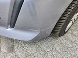 a close up of a car ' s front bumper with a sticker on it