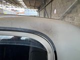 a white car that is parked inside of a building