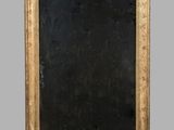 an antique gold framed mirror with a black background and a gold frame