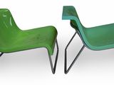 two green plastic chairs sitting next to each other on a white surface