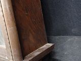a clock that is sitting on a shelf on the floor