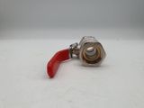 a close up of a red handle on a metal ball valve