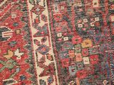 a close up of a red and blue rug with a pattern on it
