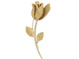 un gros plan d'une broche en forme de fleur dorée sur fond blanc