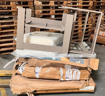 a pile of boxes and pallets in a warehouse