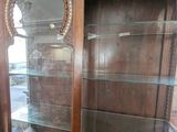 a glass display case with a mirror on top of it