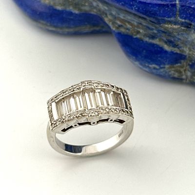 an image of a diamond ring sitting on top of a blue stone