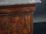 a wooden cabinet with a marble top on a black background